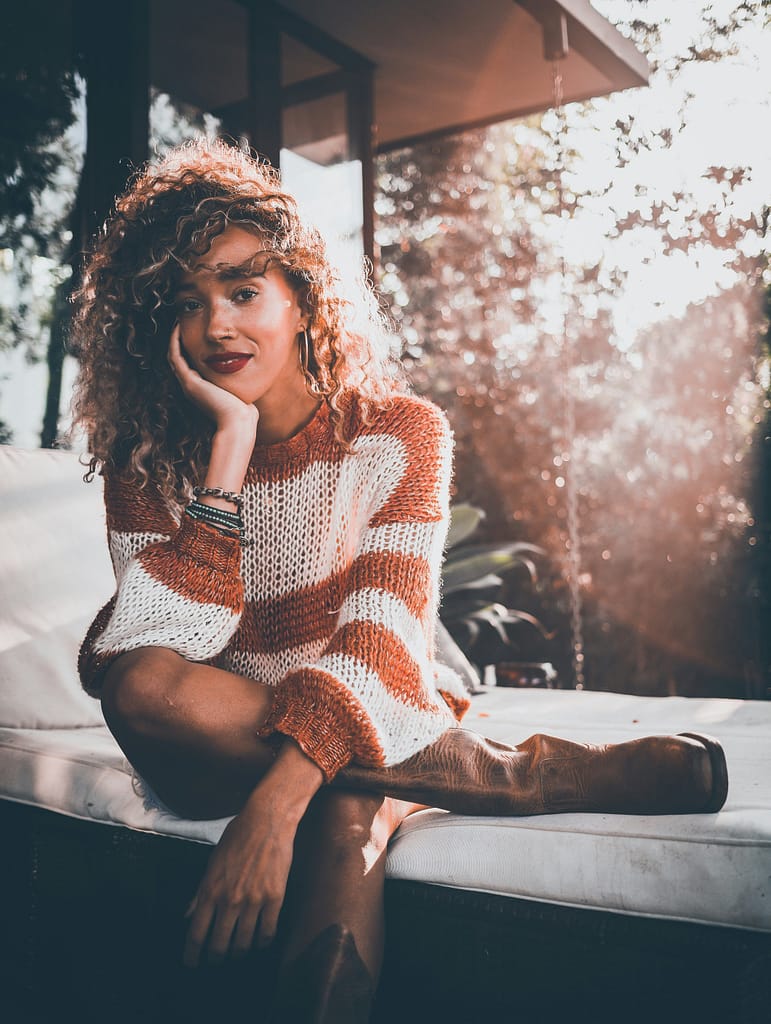 trendy hairstyles to celebrate curly hair - woman wearing brown and white long-sleeved shirt